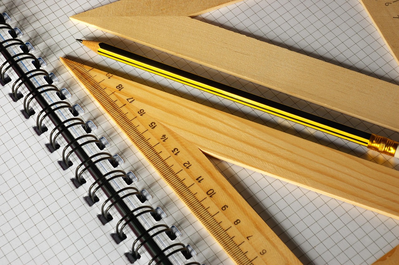 Hand being measured with a ruler from the wrist to the tip of the middle finger