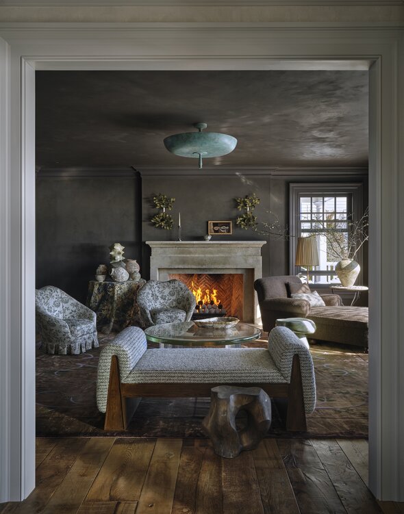 An intimate seating nook with plush velvet chairs and low-level ambient lighting.
