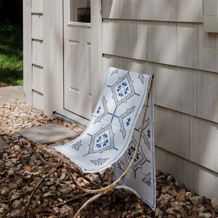 Roan Iris Table Throw No. 6271 with vibrant cobalt blue embroidery details.