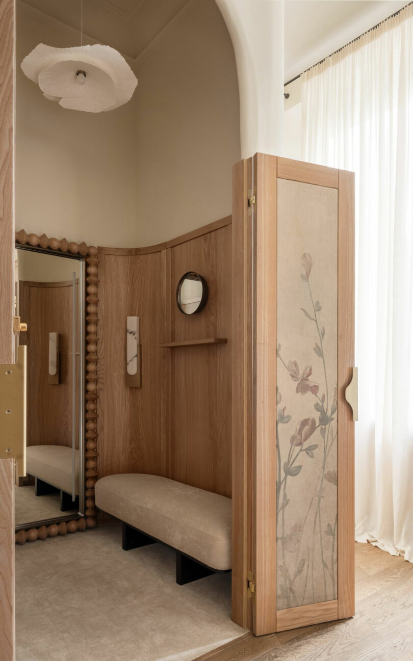 A peaceful dressing area with light wood panels, sheer curtains, and soft natural lighting.