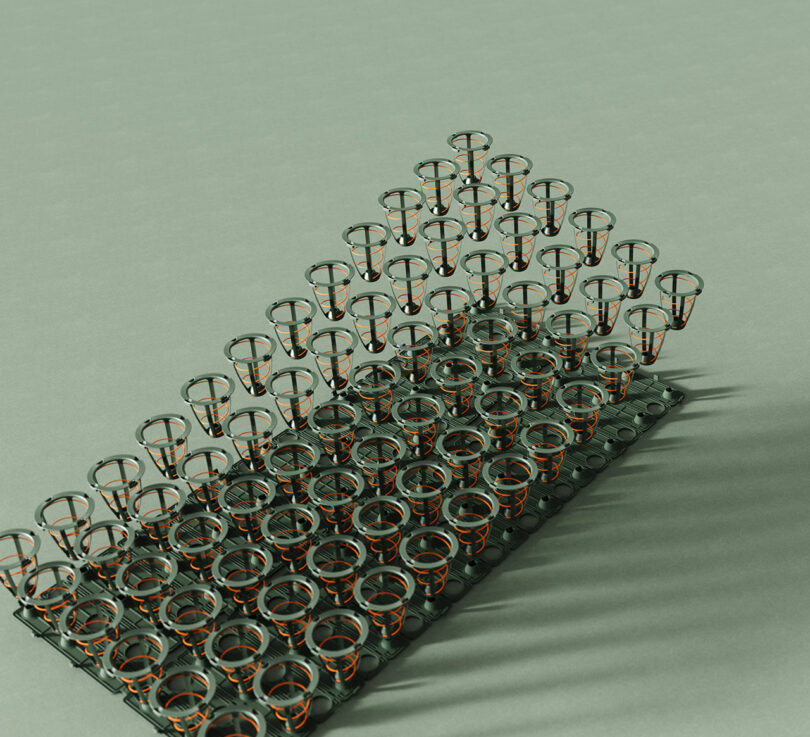 A grid of metal spring coils laid out on a light green surface.