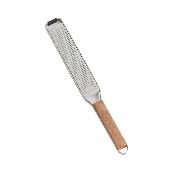 Evenly sliced delicata squash half-moons arranged on a wooden cutting board.