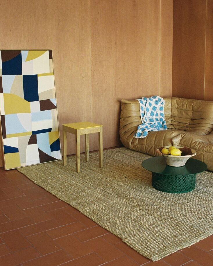 A buttery-colored Togo sofa in a Barcelona living room styled for a young family.