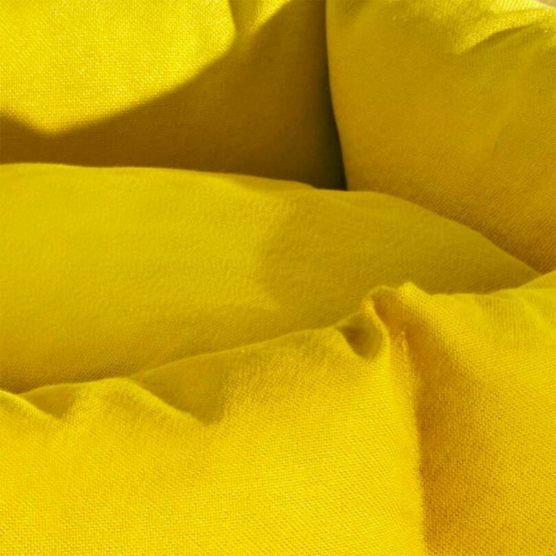 Close-up detail shot of the yellow Kvadrat museum-grade textile on a Kanto dog bed.