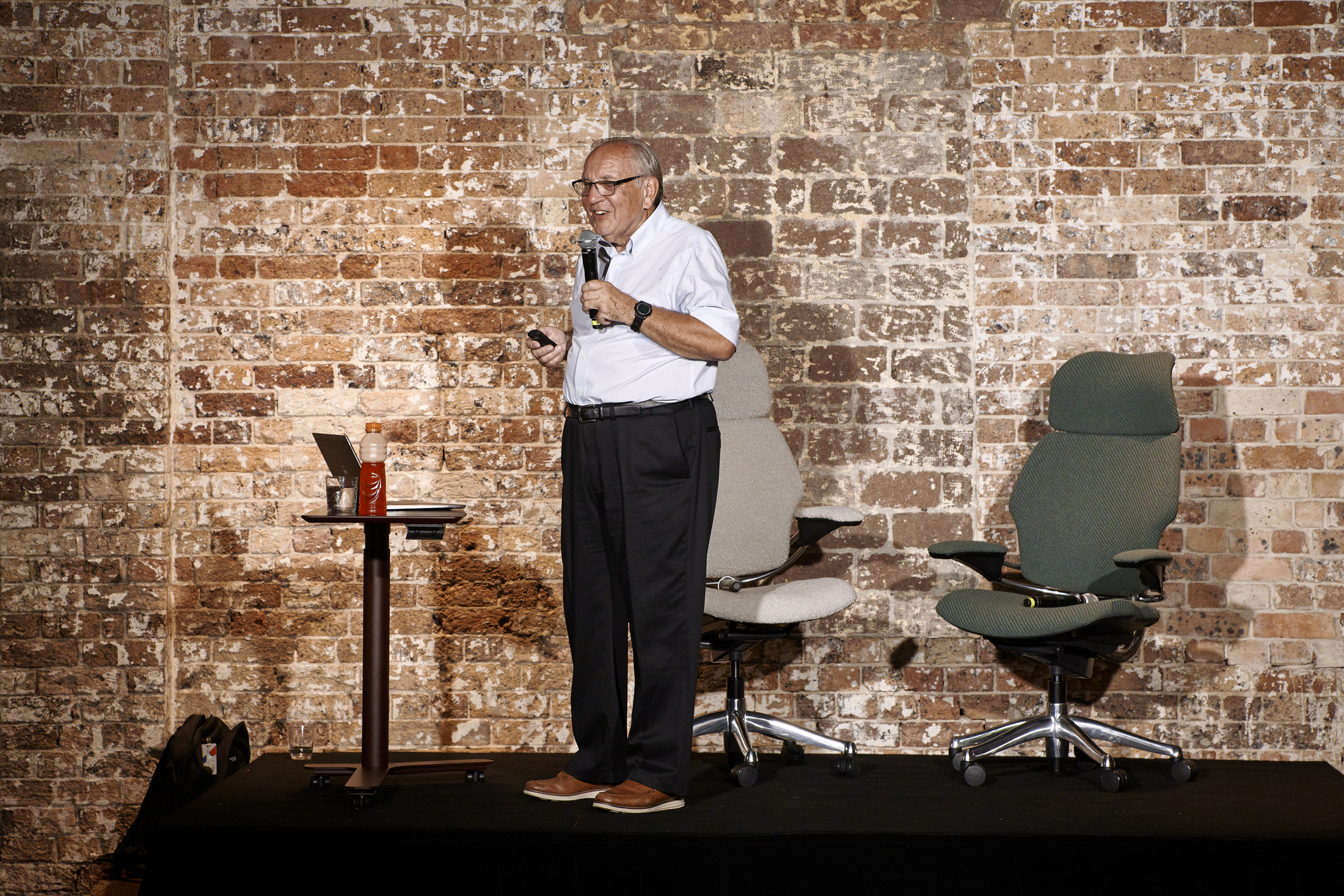 A modern desk setup featuring Humanscale monitor arms and task lighting.