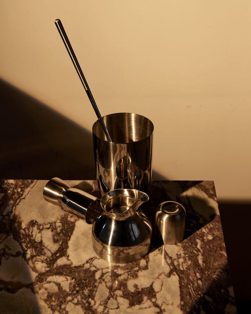 The Mescola bar tools arranged artistically on a luxurious marbled surface.