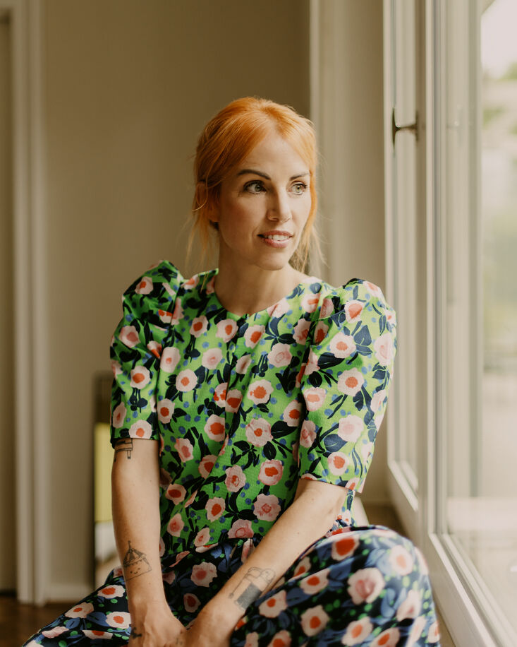 Designer Swantje Hinrichsen wearing a patterned Stine Goya dress.