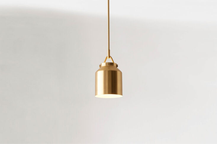 West Elm Henry Pendant light with a warm brass finish and a white glass globe.