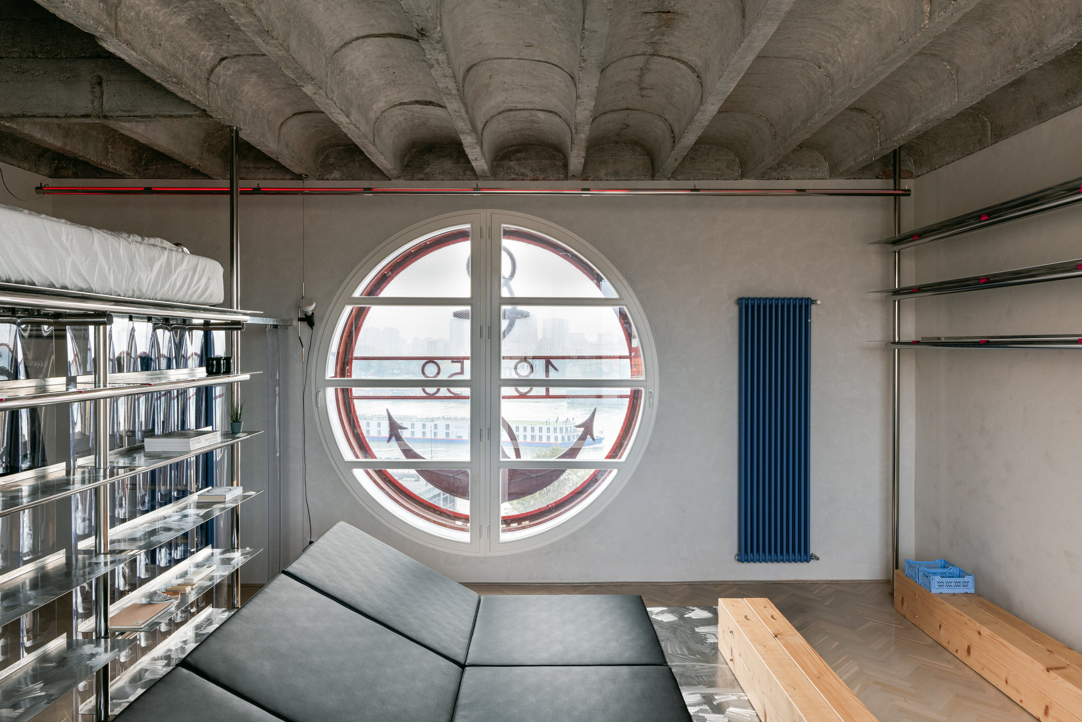 Clean architectural shot of the bedroom area partitioned by the 3D-printed steel frame.