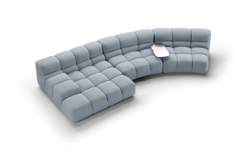A blue tufted modular sofa featuring a built-in side table made of wood and aluminum.