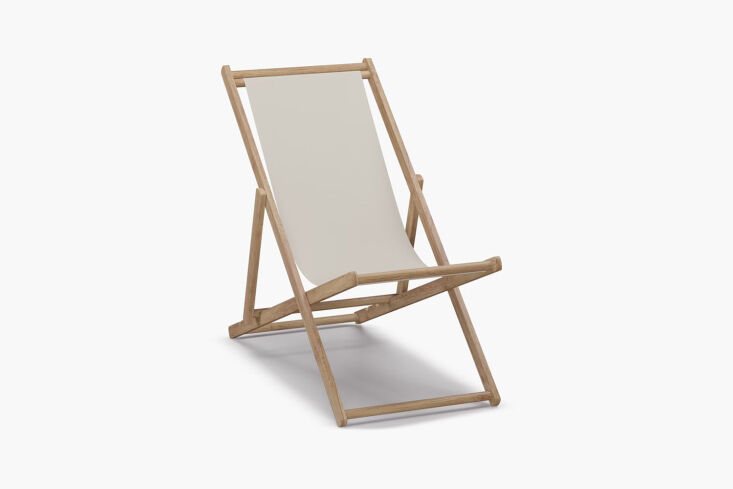 A vintage Japanese wooden deck chair with white canvas seating.