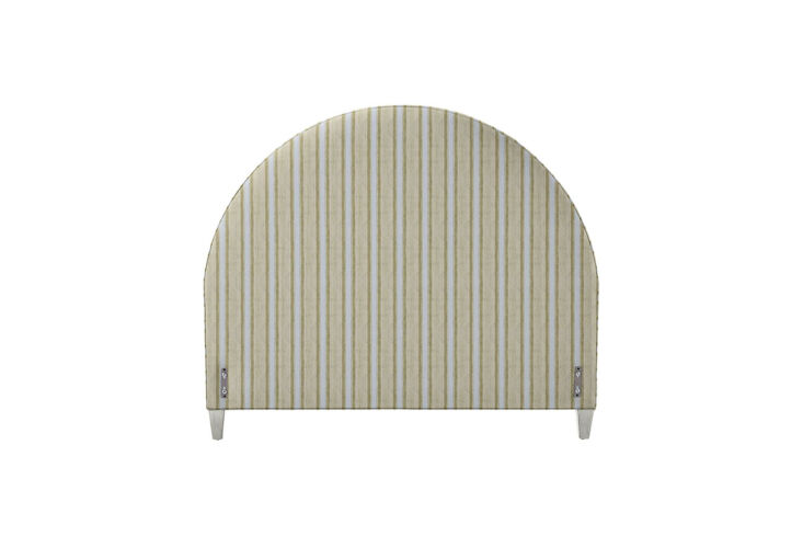 The Serena & Lily Buchanan half-moon upholstered headboard in a light neutral fabric.