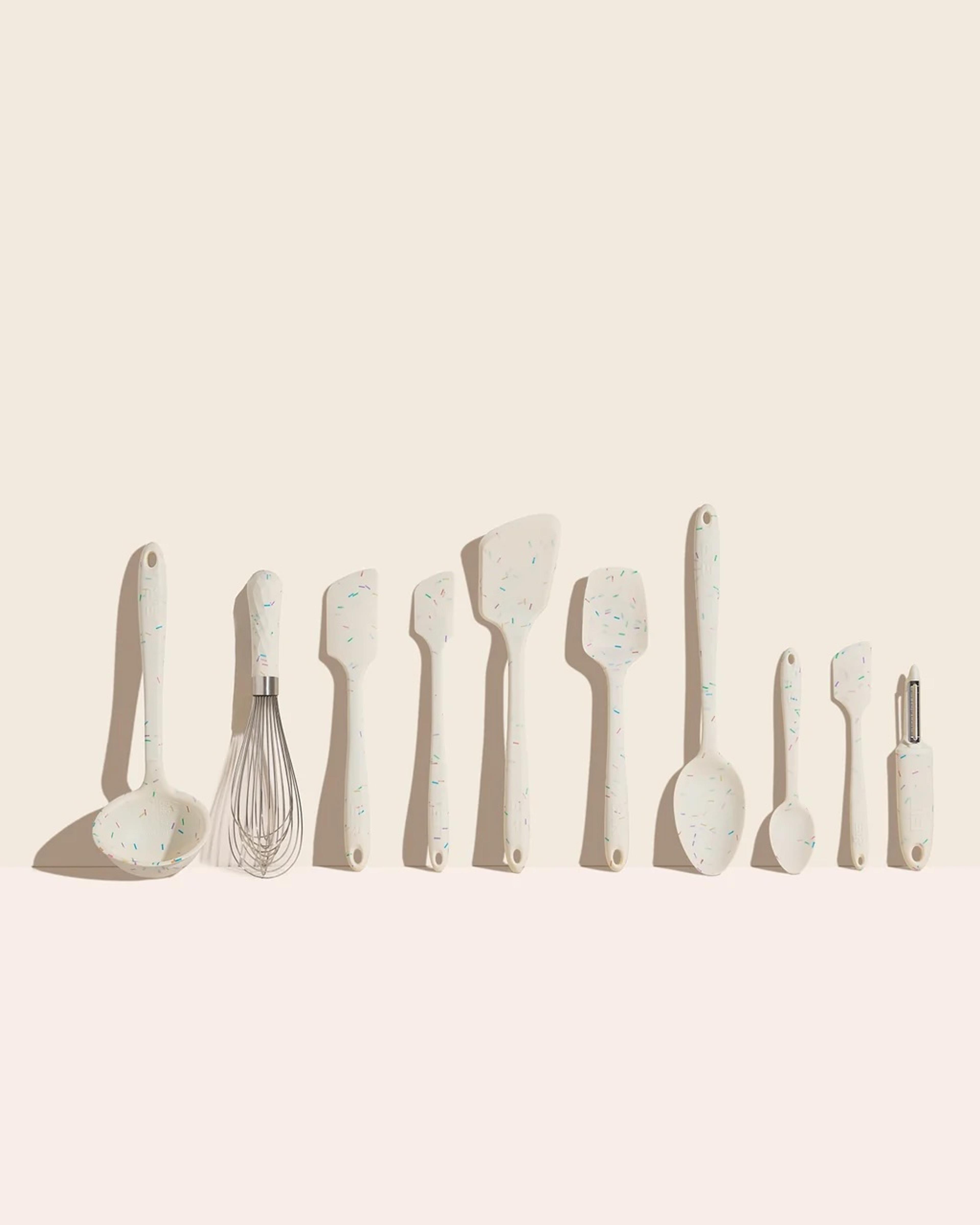 A collection of colorful silicone kitchen utensils including spatulas and spoons.