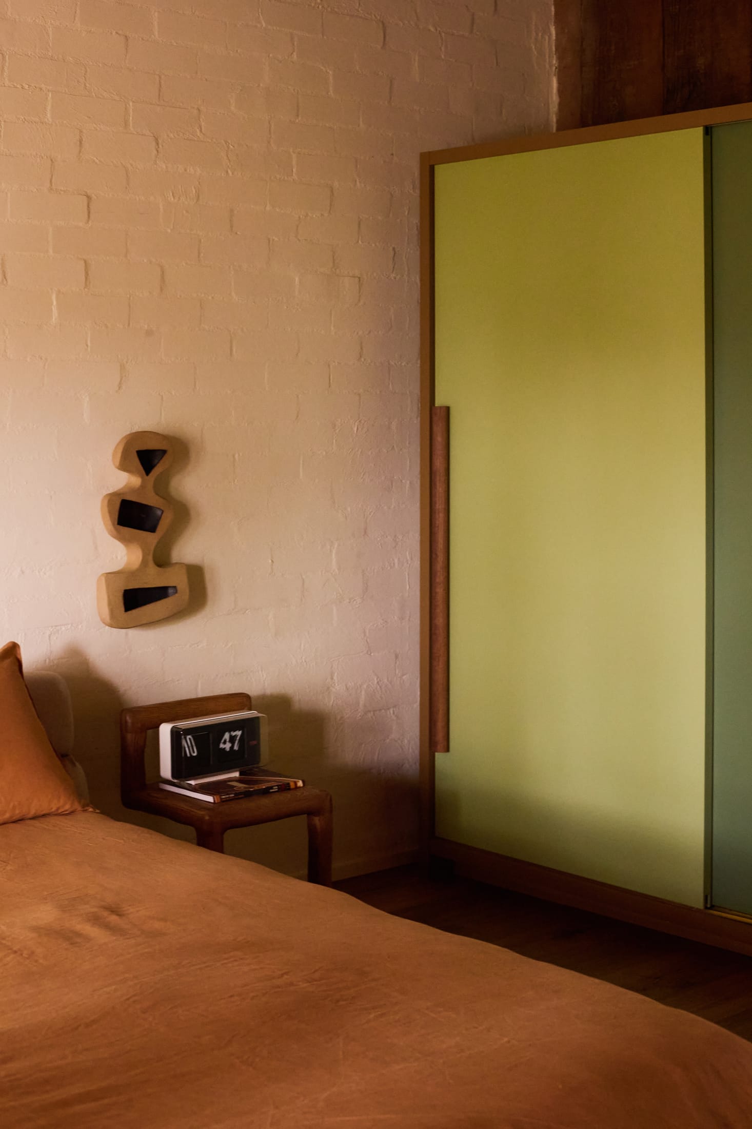 A long view of a dining and living area showing seamless timber flooring throughout.