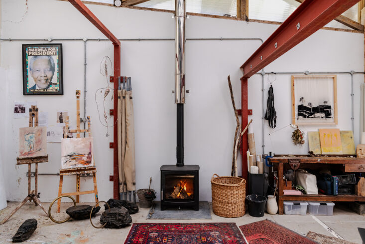 Detail shot of paint splatters and art supplies on the studio floor.