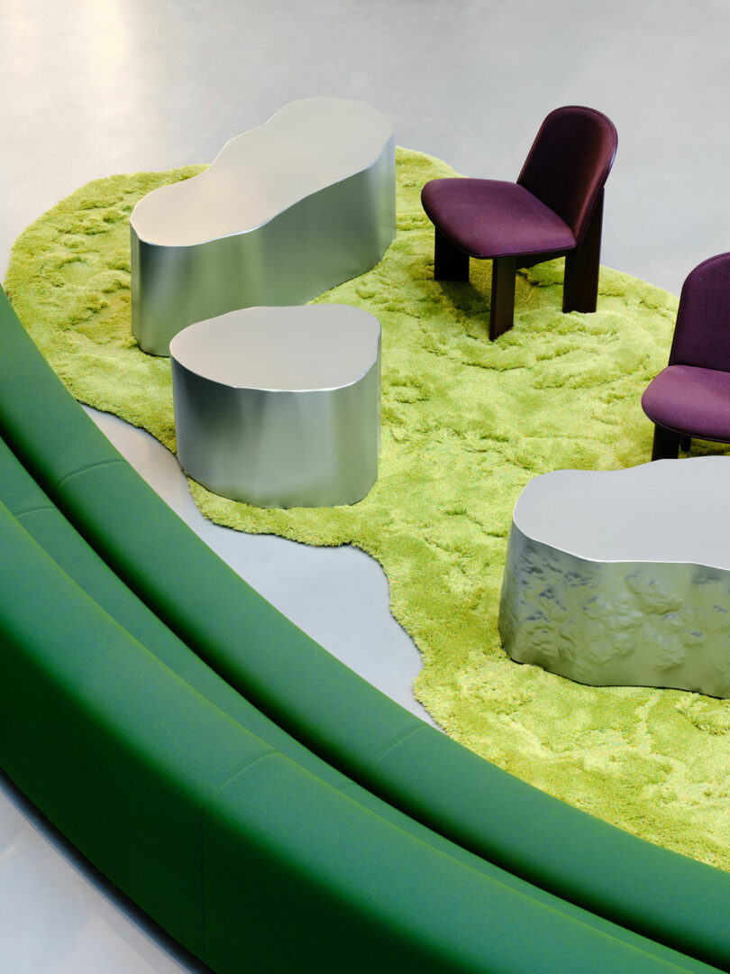 Curved green bench and purple chairs on a textured green rug in a modern interior.
