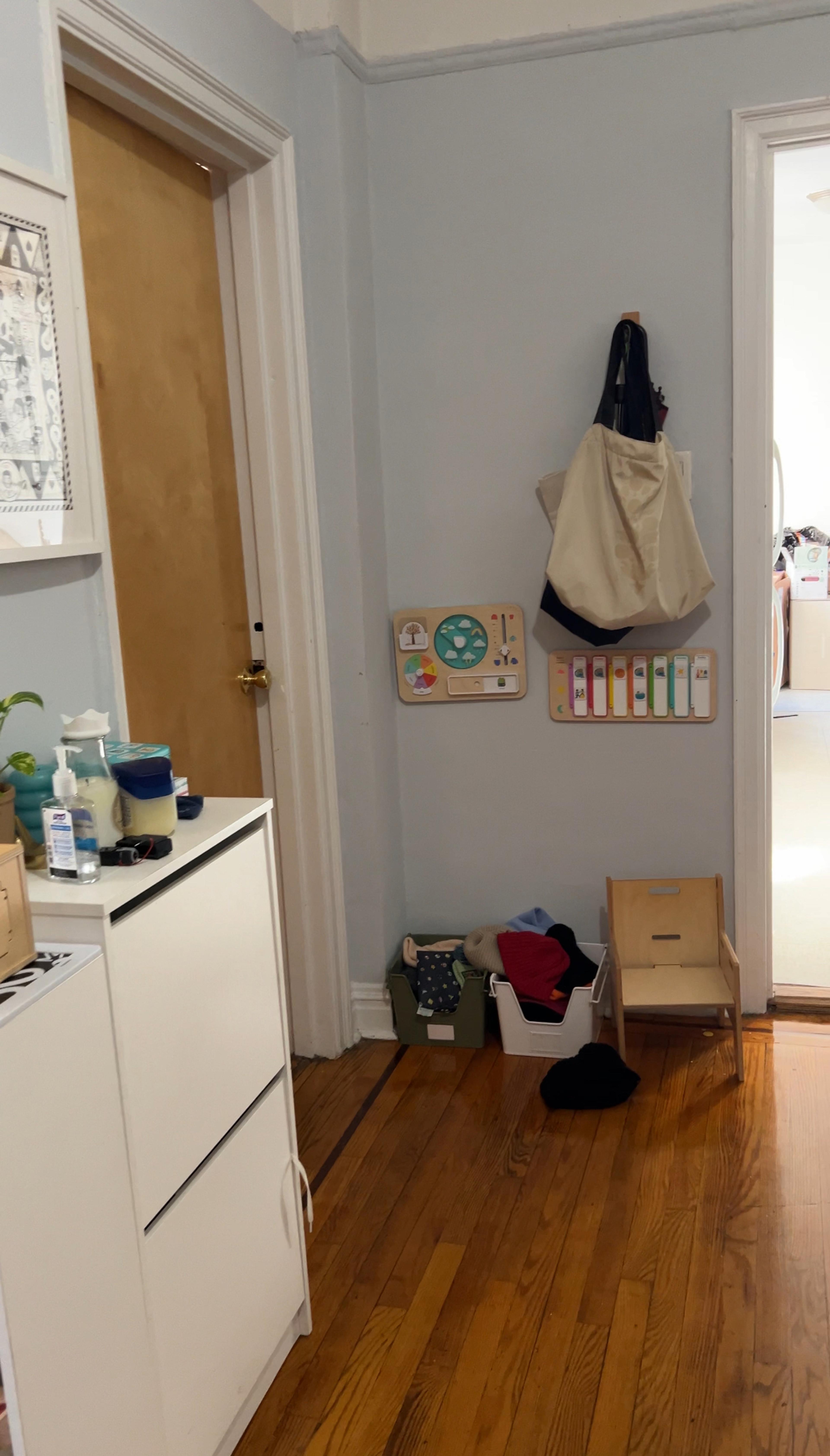A cluttered entryway with shoes and bags scattered haphazardly across the floor.
