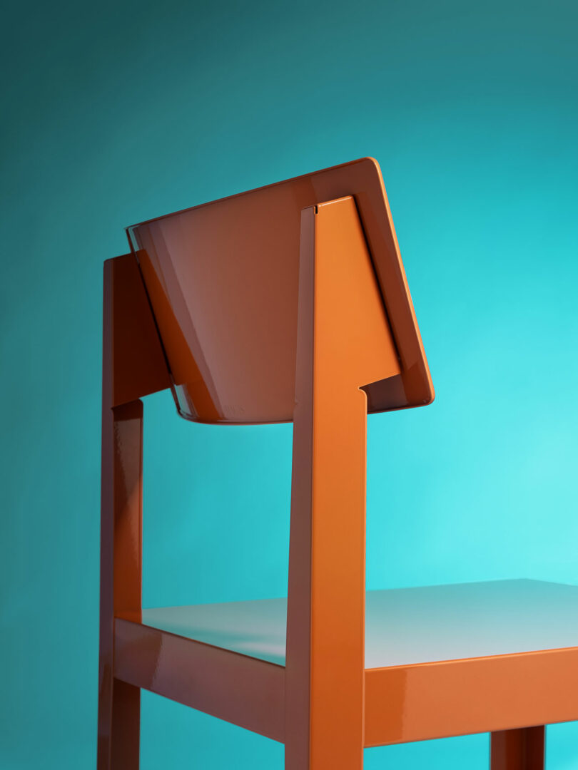 Orange modern chair with an angled backrest shown against a gradient blue background.