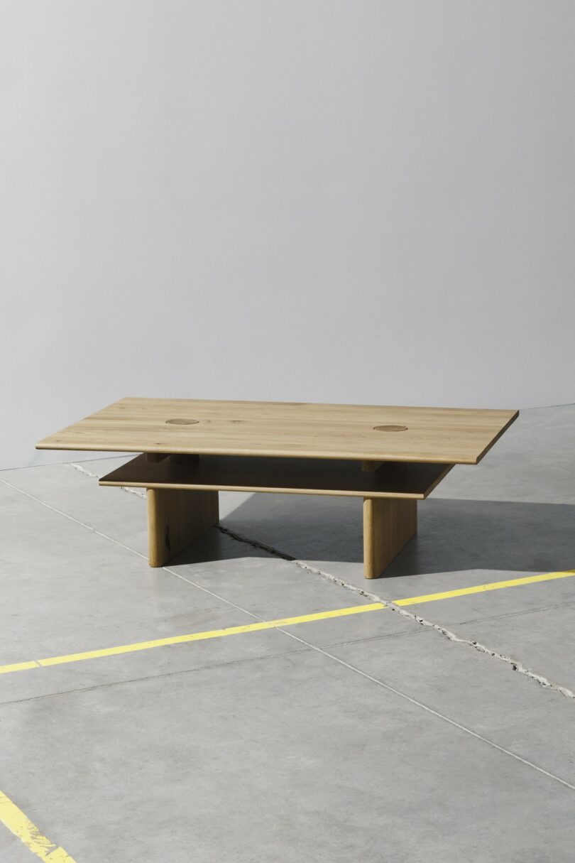 A rectangular wooden coffee table with a flat top and a lower shelf for storage.