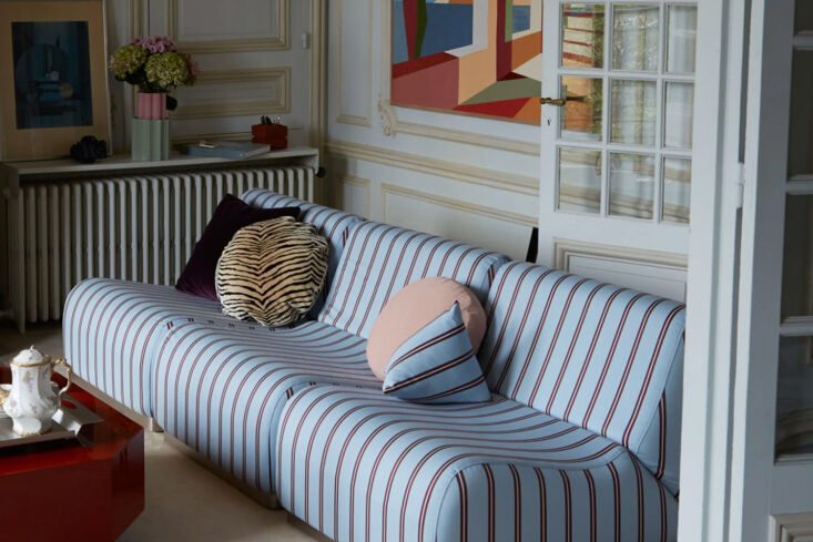 The Socialite Family Rotondo Sofa with modular segments and burgundy/blue stripes.