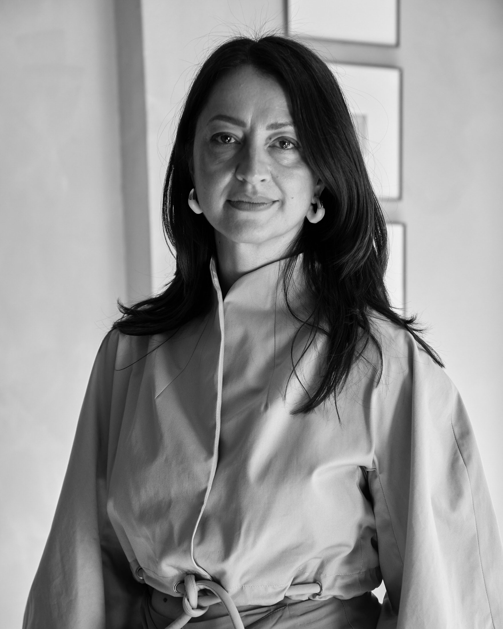 Dana Tomić Hughes in a stylish architectural interior reflecting contemporary design aesthetics.