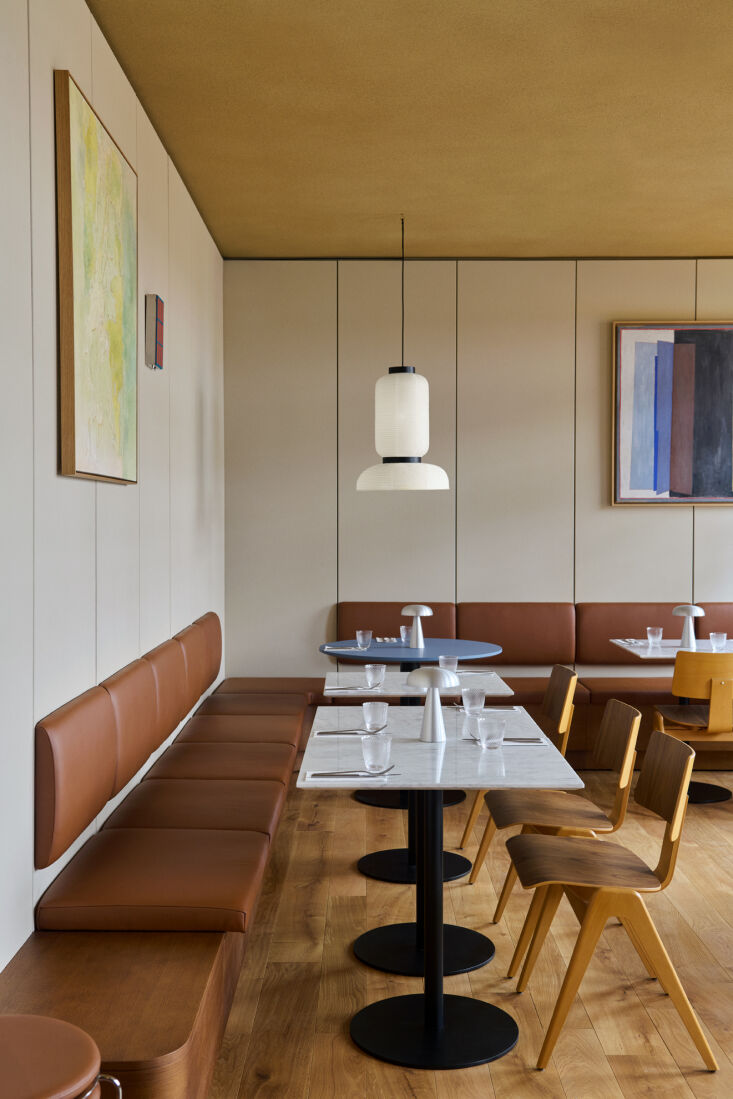 The Petra Bar & Restaurant area featuring Formakami paper pendants and custom leather-upholstered seating.