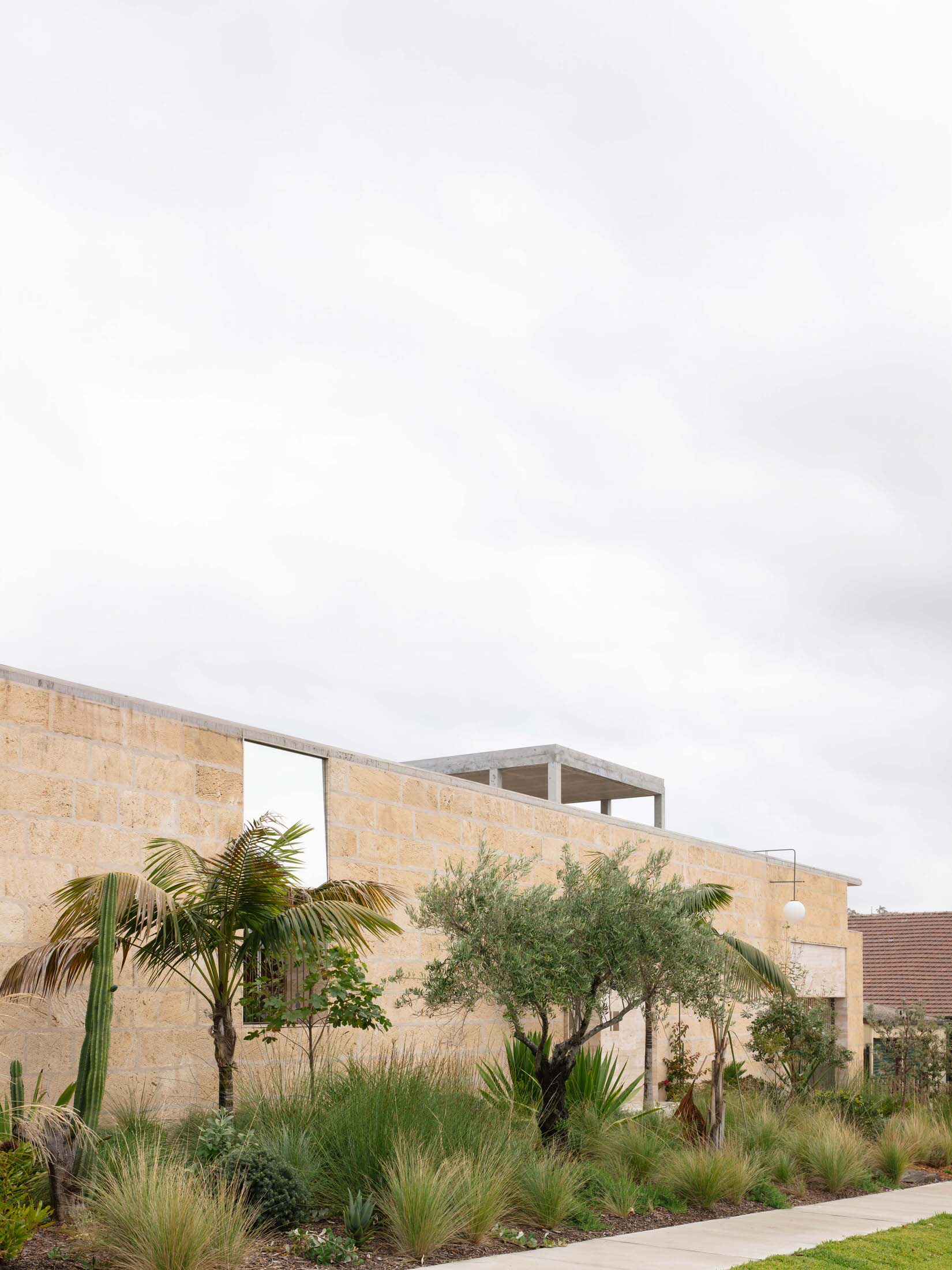 Exterior view of the New Castle house showcasing the holistic integration of structure and landscape.