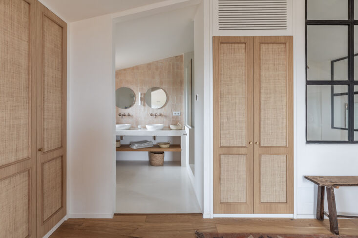 A textured wall finished with natural lime plaster showing subtle color variations.