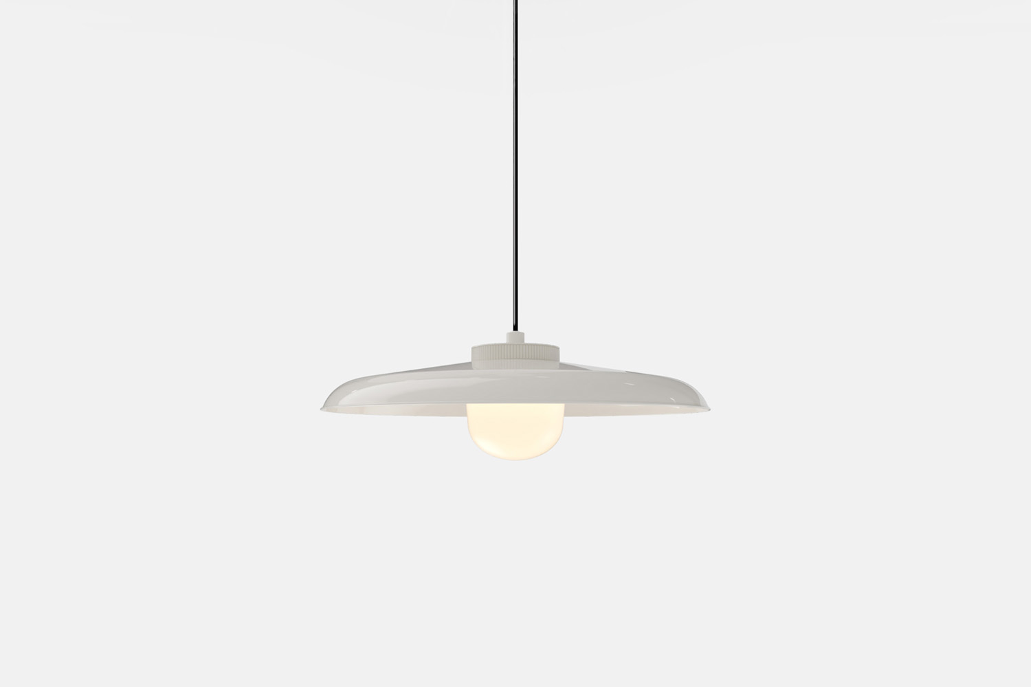 A large-scale minimalist disc pendant light with a nautical-inspired cable and industrial finish.