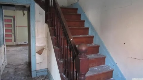 Exterior view of the Rivertown house in a state of severe disrepair before renovation.