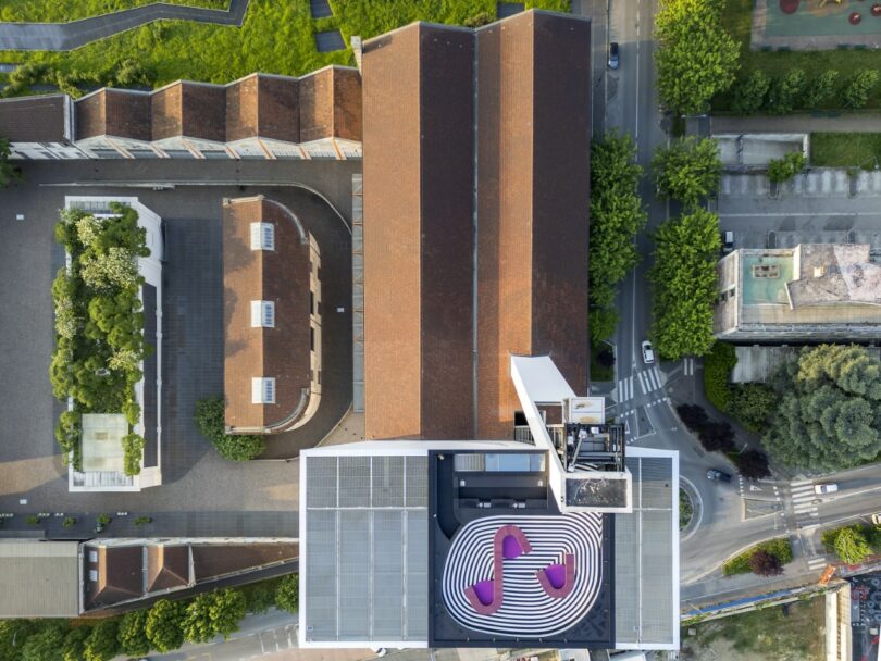 Aerial view of the Fondazione Prada complex in Milan, showing a rooftop with a distinct black and white swirl pattern.