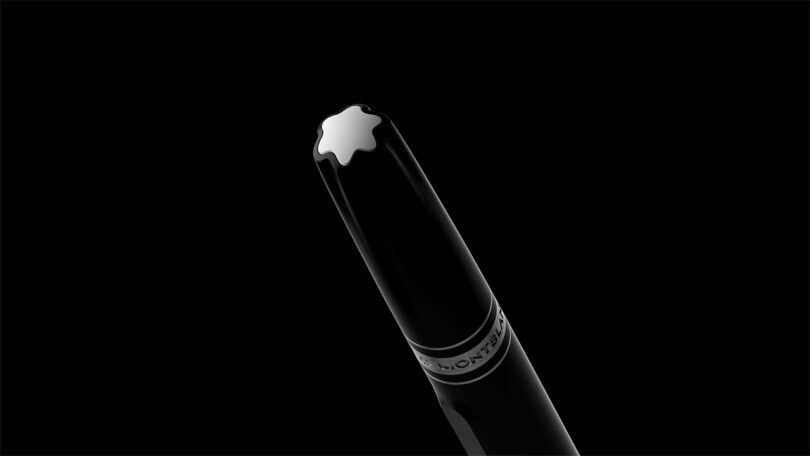 Close-up of the Montblanc star emblem on the pen cap against a black background.