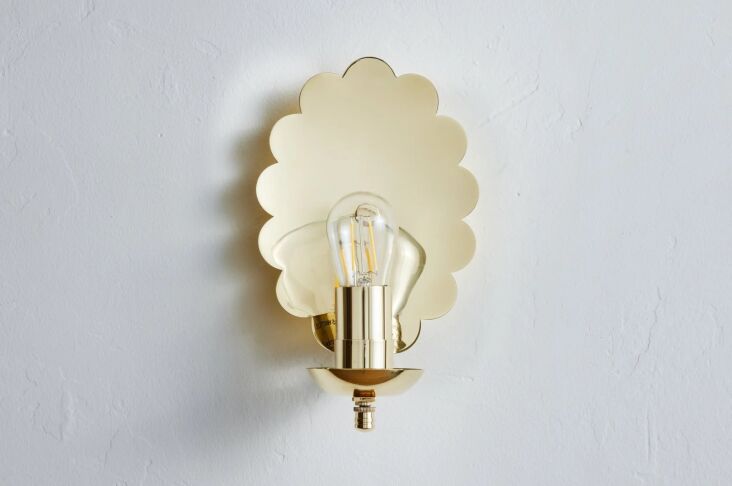 The Nickey Kehoe Scallop Sconce in brass, showing its distinctive wavy edges.