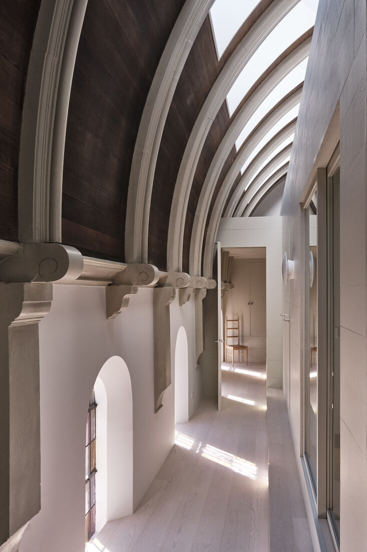 Close-up of mineral-painted walls meeting the original brickwork of the chapel.