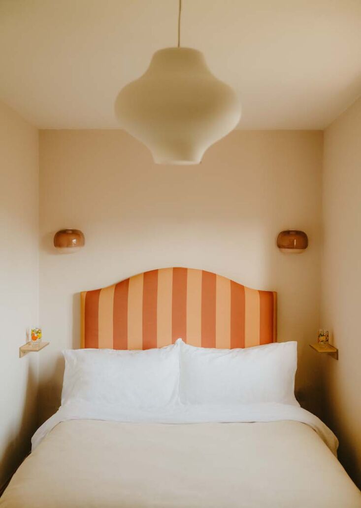 A large headboard featuring wide yellow and terracotta stripes.