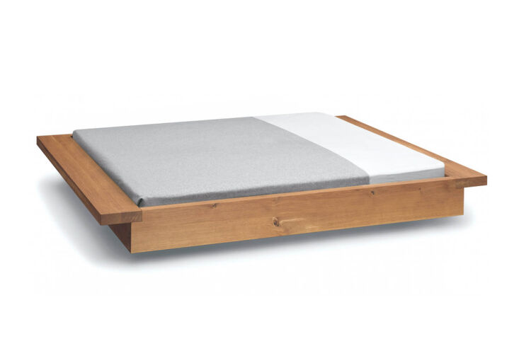 A luxury European oak platform bed with a deep-welled tray design to hold a mattress.