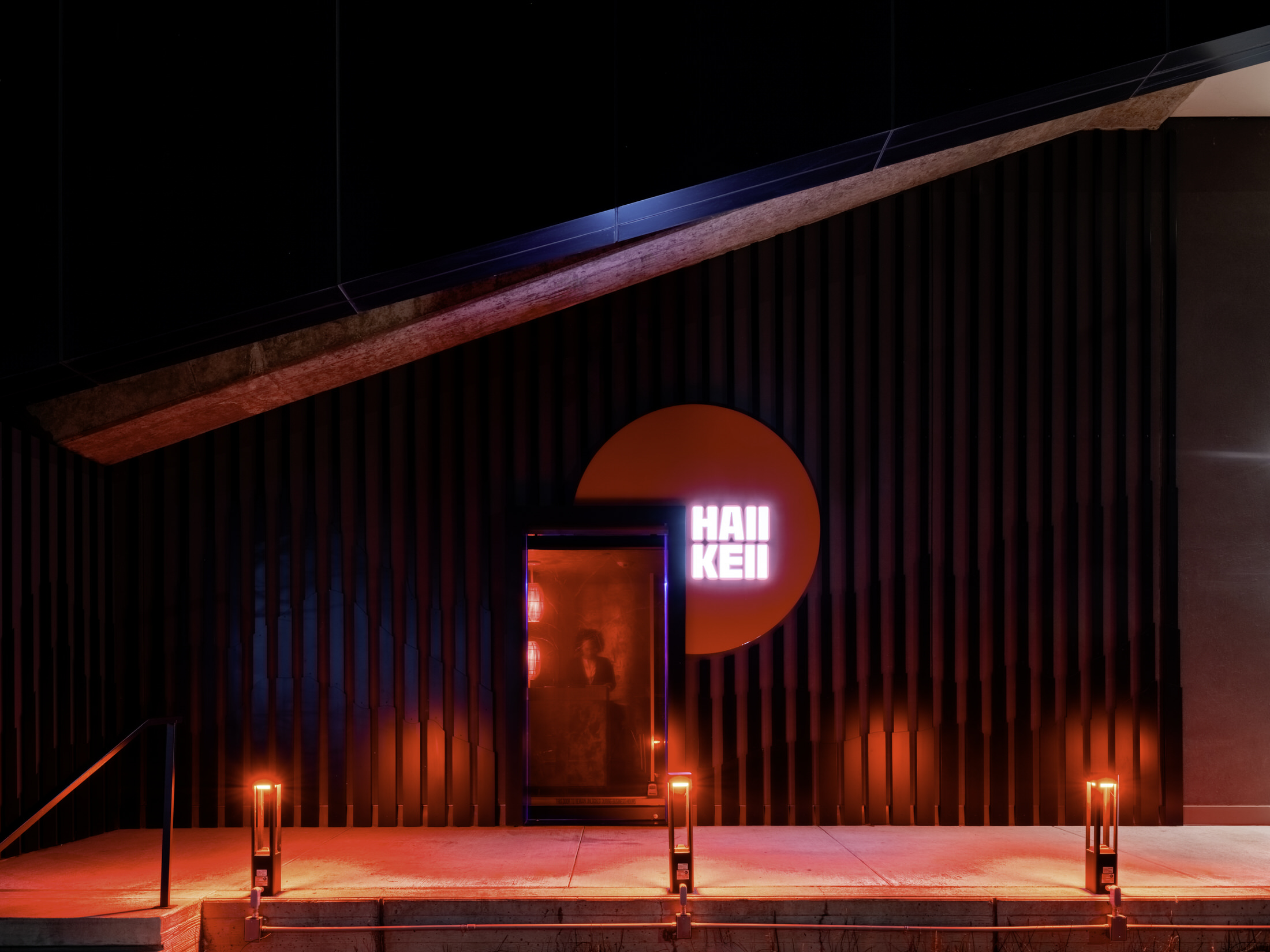 Circular floor-to-ceiling portal opening into a private dining area with velvet drapes.