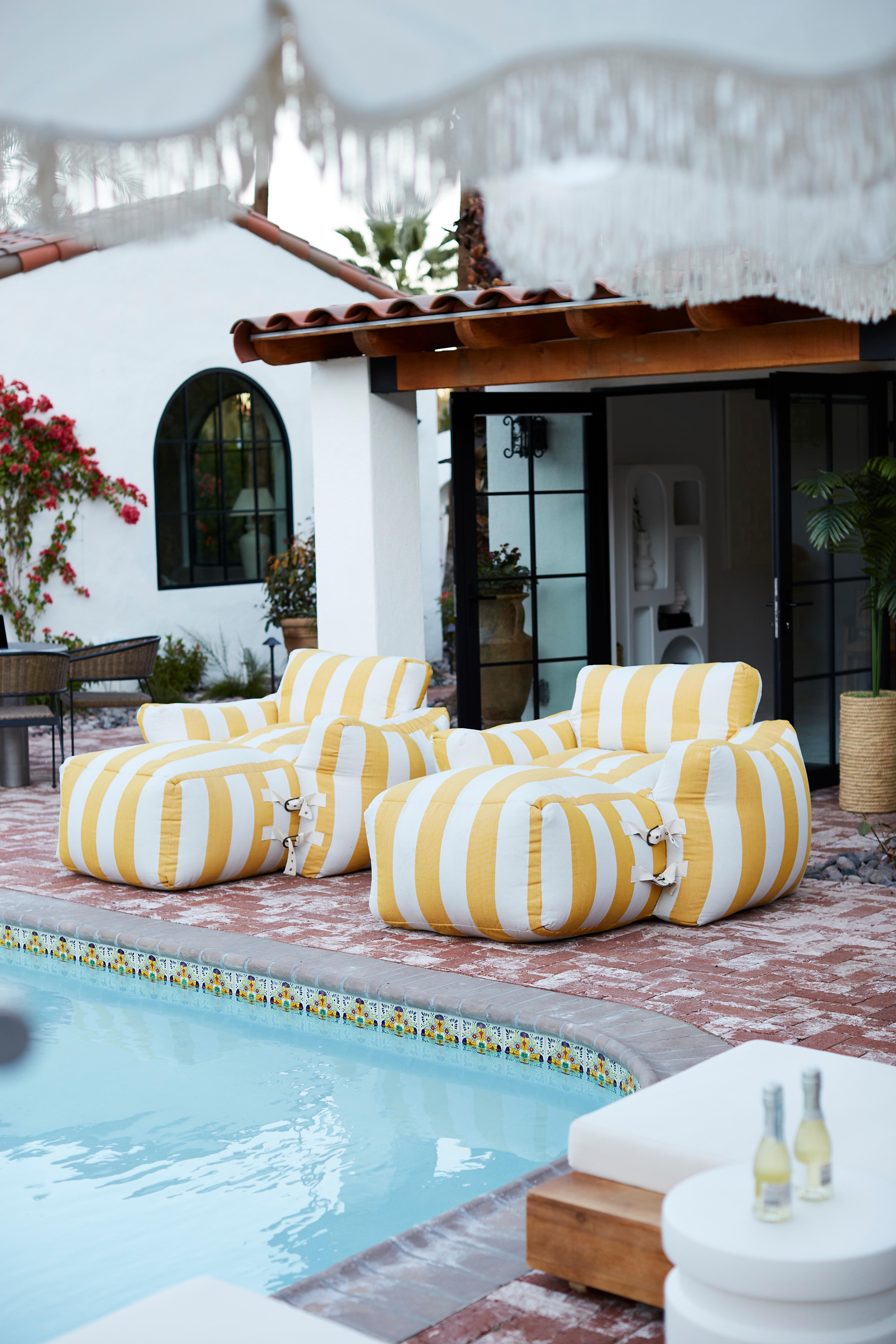 Elegant striped lounge chairs positioned for relaxation in an outdoor setting.