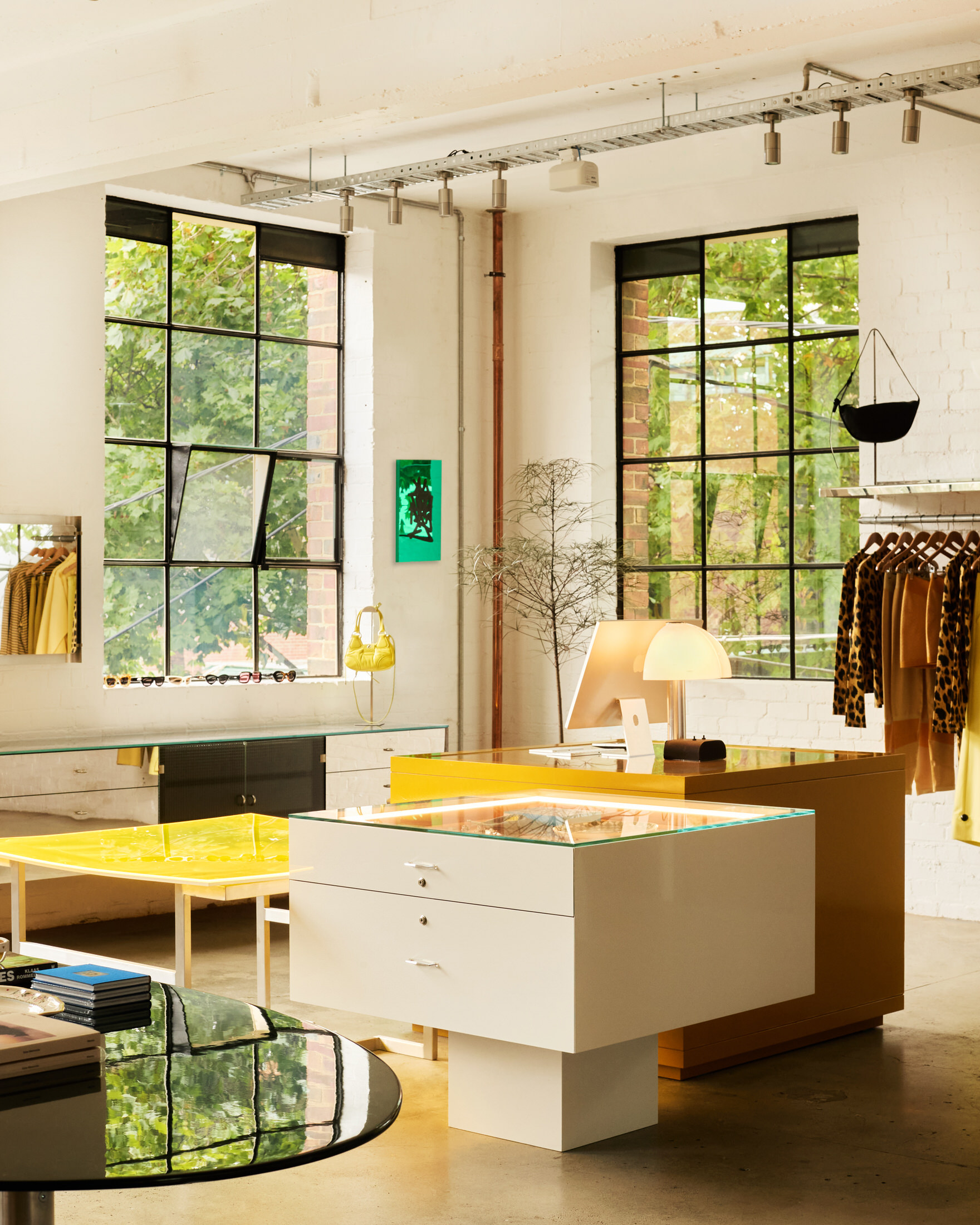 The Mane by Stable retail space on the ground floor with minimalist clothing racks and timber accents.