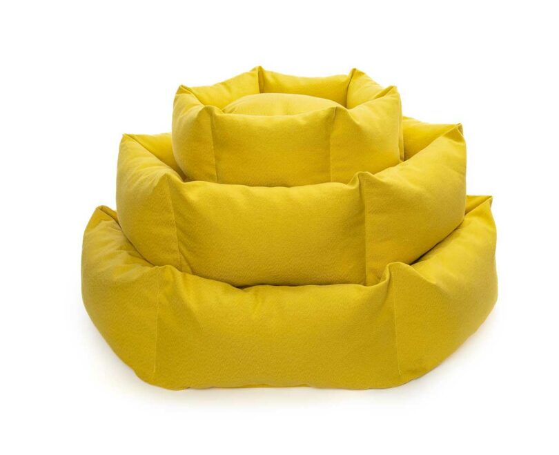 A stack of colorful circular Luoto dog beds showcasing the sustainable textile palette.