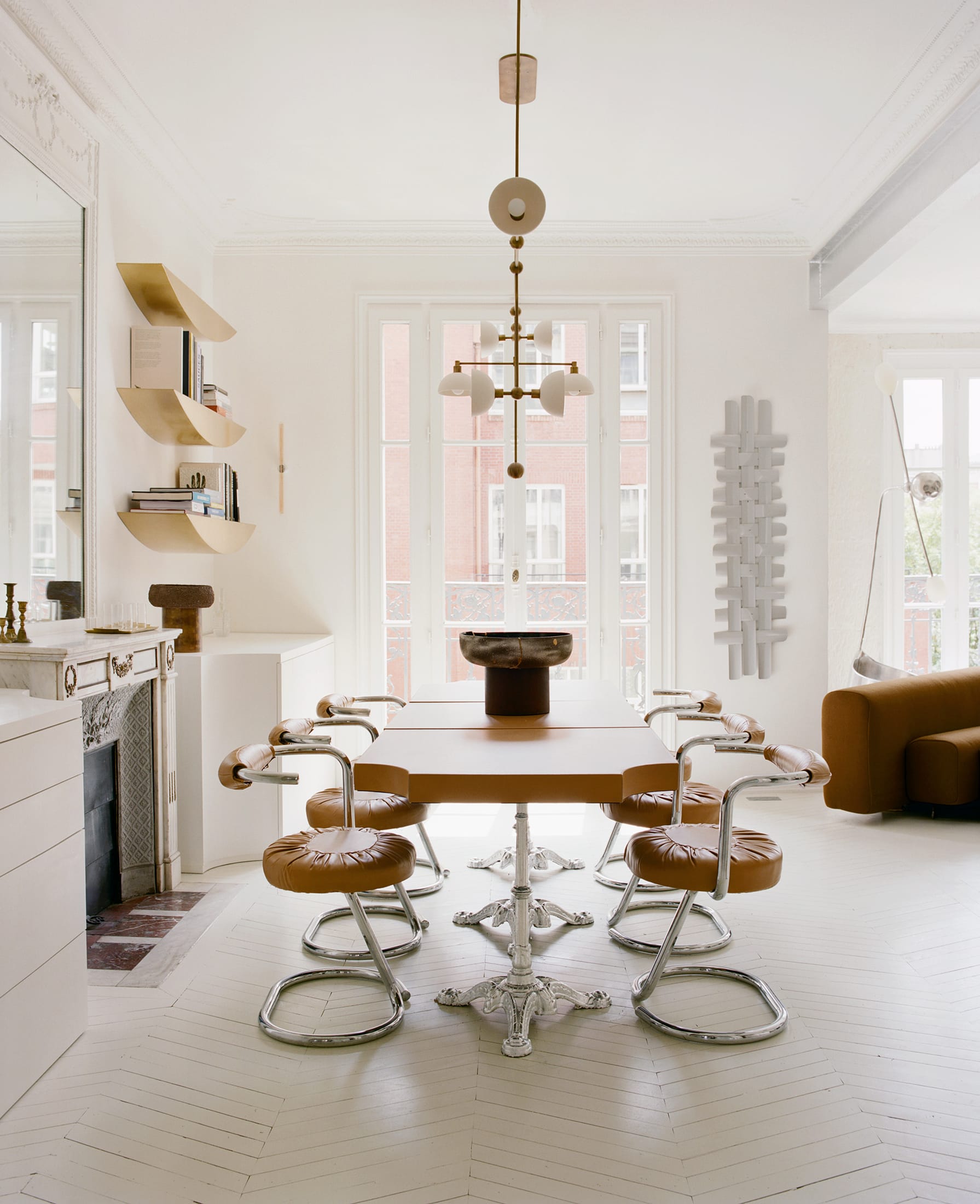 Interior detail featuring a vibrant tomato red wall accent and sculptural design elements.