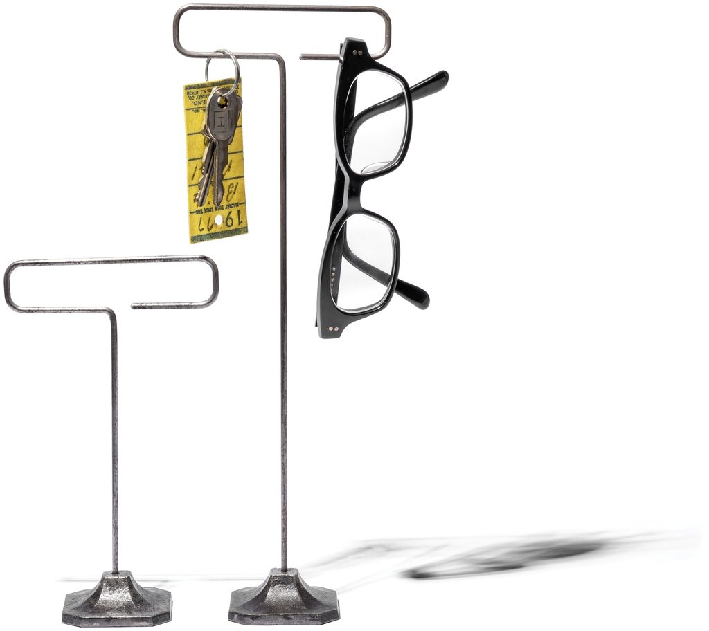 Steel wire display stands by Puebco holding eyeglasses in an industrial style.