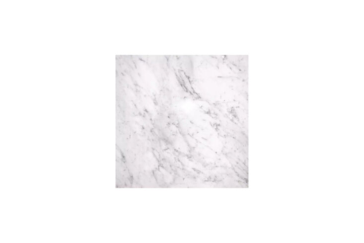 A Bianco Carrara prefabricated marble countertop showing a clean, clear prep surface in a small kitchen.