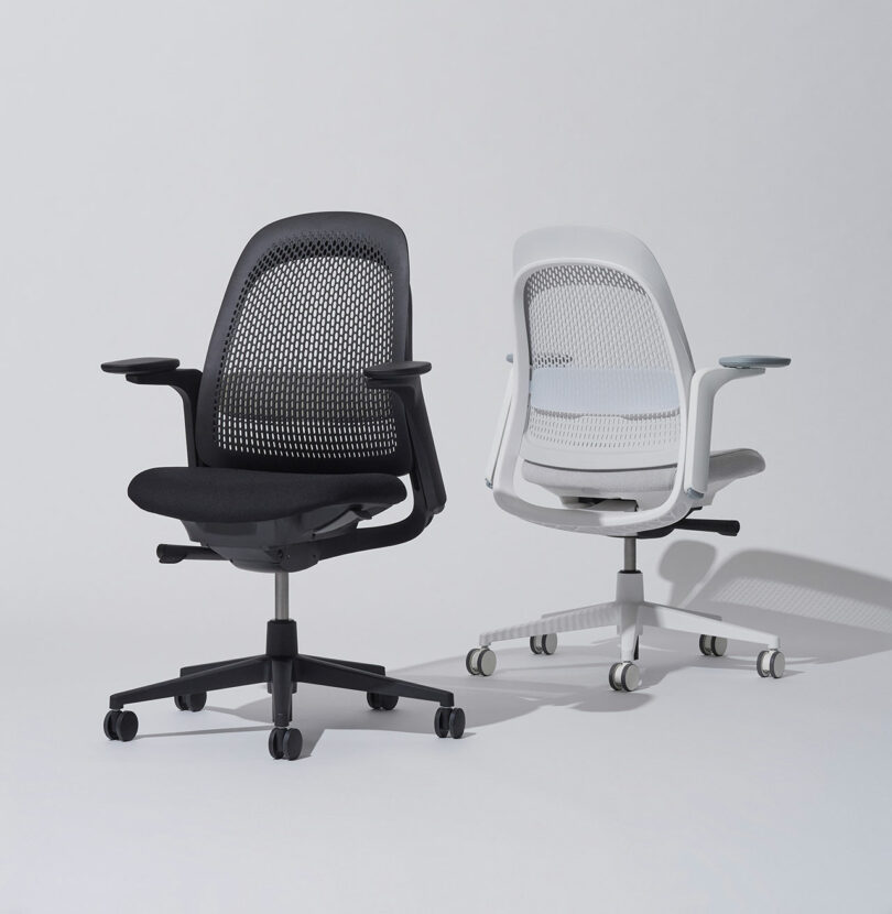A pair of Breck chairs in black and white, displaying the contrast between frame and mesh options.