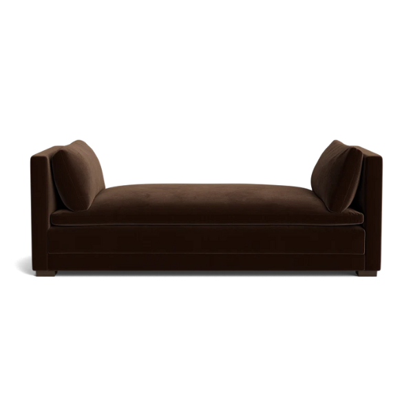 A daybed featuring curved wooden edges and high-quality linen upholstery.