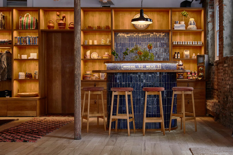 The in-store bar area with wooden stools and a tiled counter.