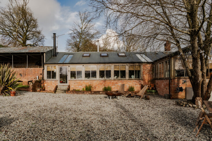 Exterior view of the converted Victorian bothy and surrounding garden structures.