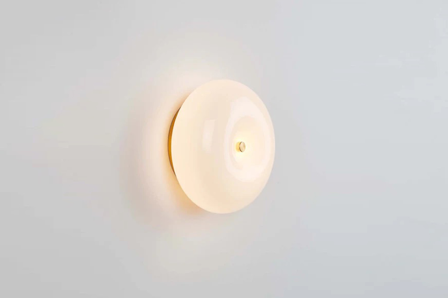 A Roll & Hill Pillow Sconce 01 made of hand-blown Italian glass and brass hardware.