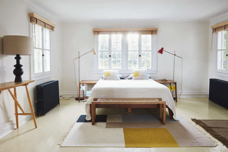 Full view of a bedroom interior showcasing a palette of yellow, dark gray, and pale purple.