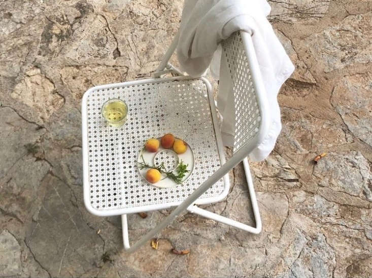 Slices of fresh peaches served on a minimalist white ARC Objects ceramic plate outdoors.
